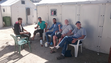 Volunteers having tea with refugees in Lesbos camp
